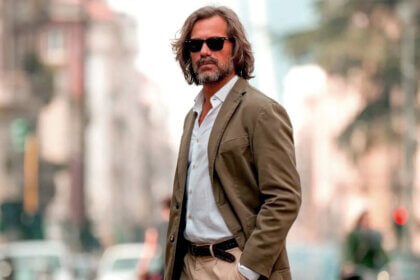 Stylish woman wearing navy Blazertje jacket with jeans for smart casual look demonstrating versatile Dutch blazer styling