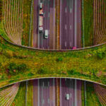Greener highways construction showing recycled materials and sustainable road building techniques with solar panels and green infrastructure