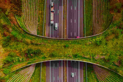 Greener highways construction showing recycled materials and sustainable road building techniques with solar panels and green infrastructure