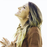 Rebecca St James performing on stage contributing to her net worth through concert revenue
