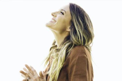 Rebecca St James performing on stage contributing to her net worth through concert revenue