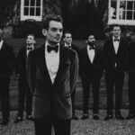 Elegant winter black tie outfit with velvet gown and tailored overcoat for formal cold weather events