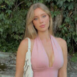 Daisy Keech Net Worth 2025 fitness influencer posing in pink halter dress outdoors