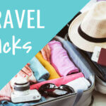 Travel hacks packing suitcase with colorful rolled clothes, passport, sunglasses, hat and camera for Cwbiancavoyage tips