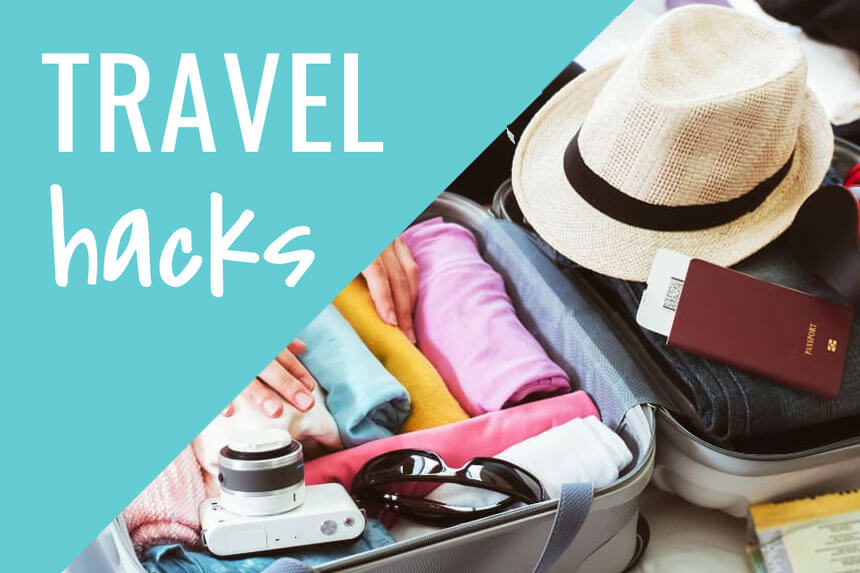 Travel hacks packing suitcase with colorful rolled clothes, passport, sunglasses, hat and camera for Cwbiancavoyage tips