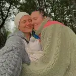Julie and Camilla Lorentzen smiling together outdoors with their baby, Norwegian influencer couple discussing net worth